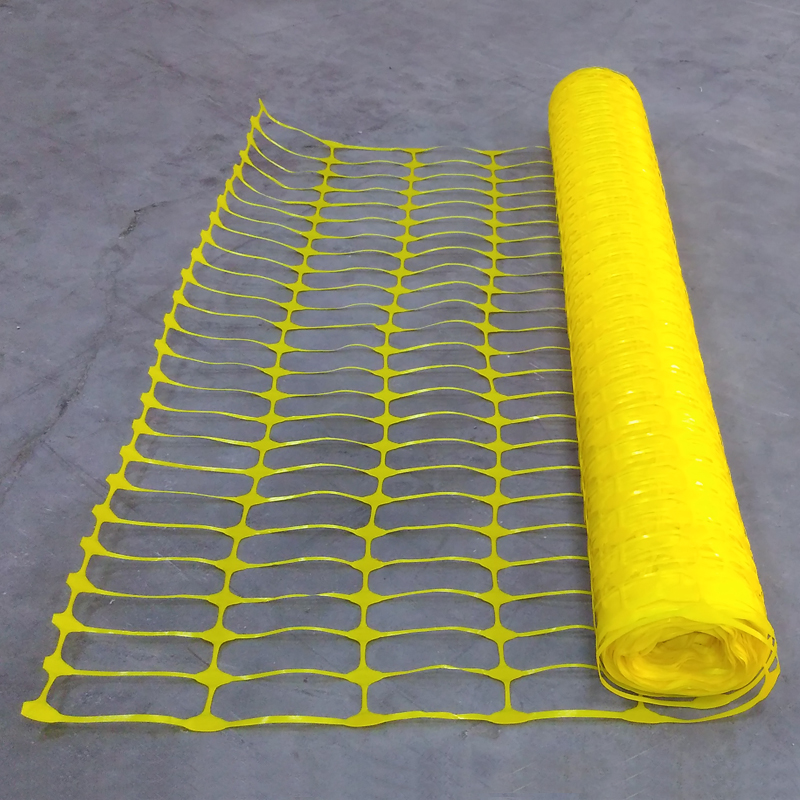 Yellow plastic mesh barrier safety fencing + steel fencing pins